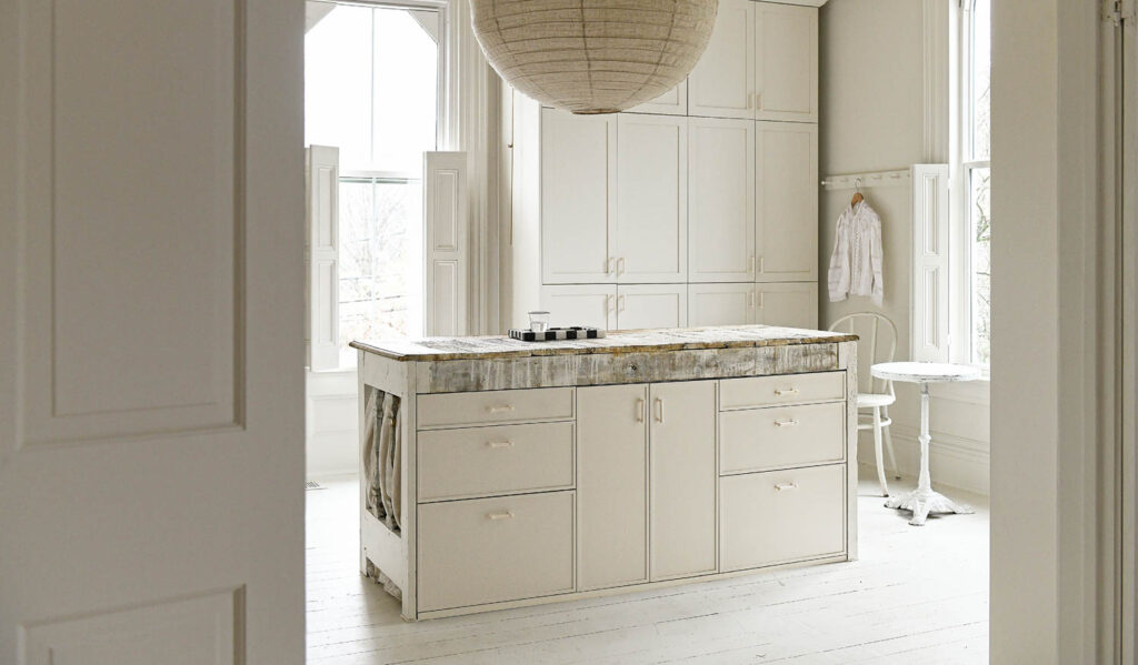 kitchen with all-white cabinets, lantern and flooring