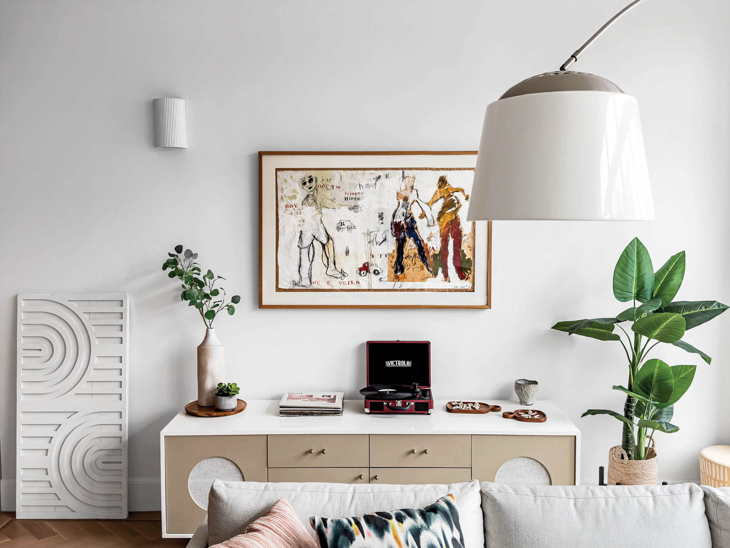 room with quirky artwork, plants and console