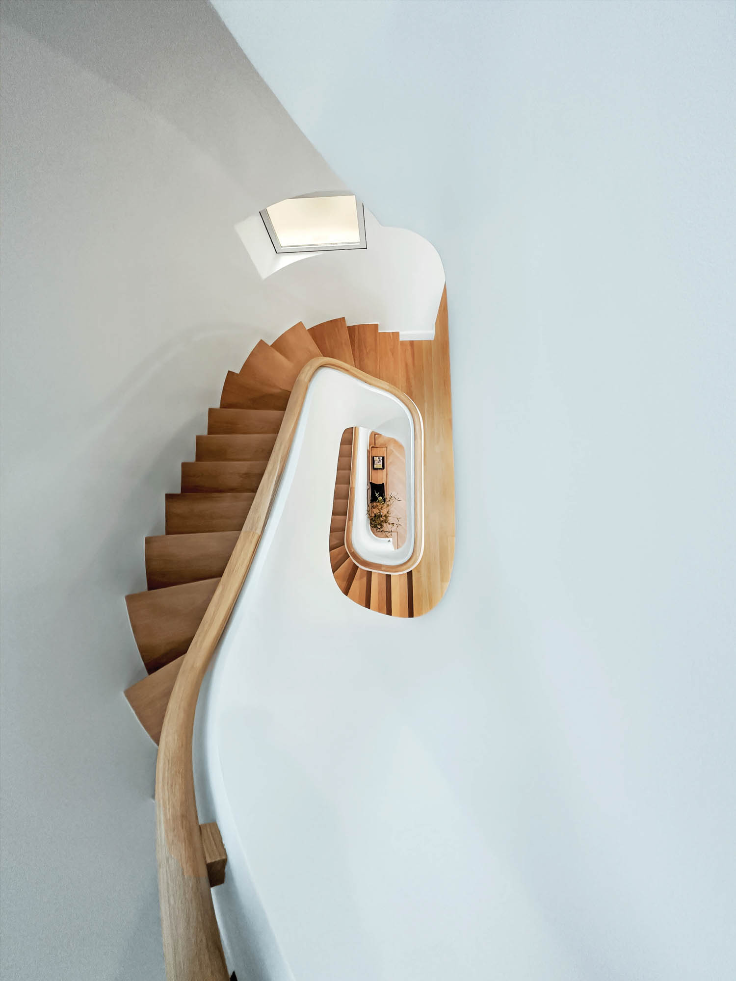 four-story town house connected by handrail and stairs in stained white oak