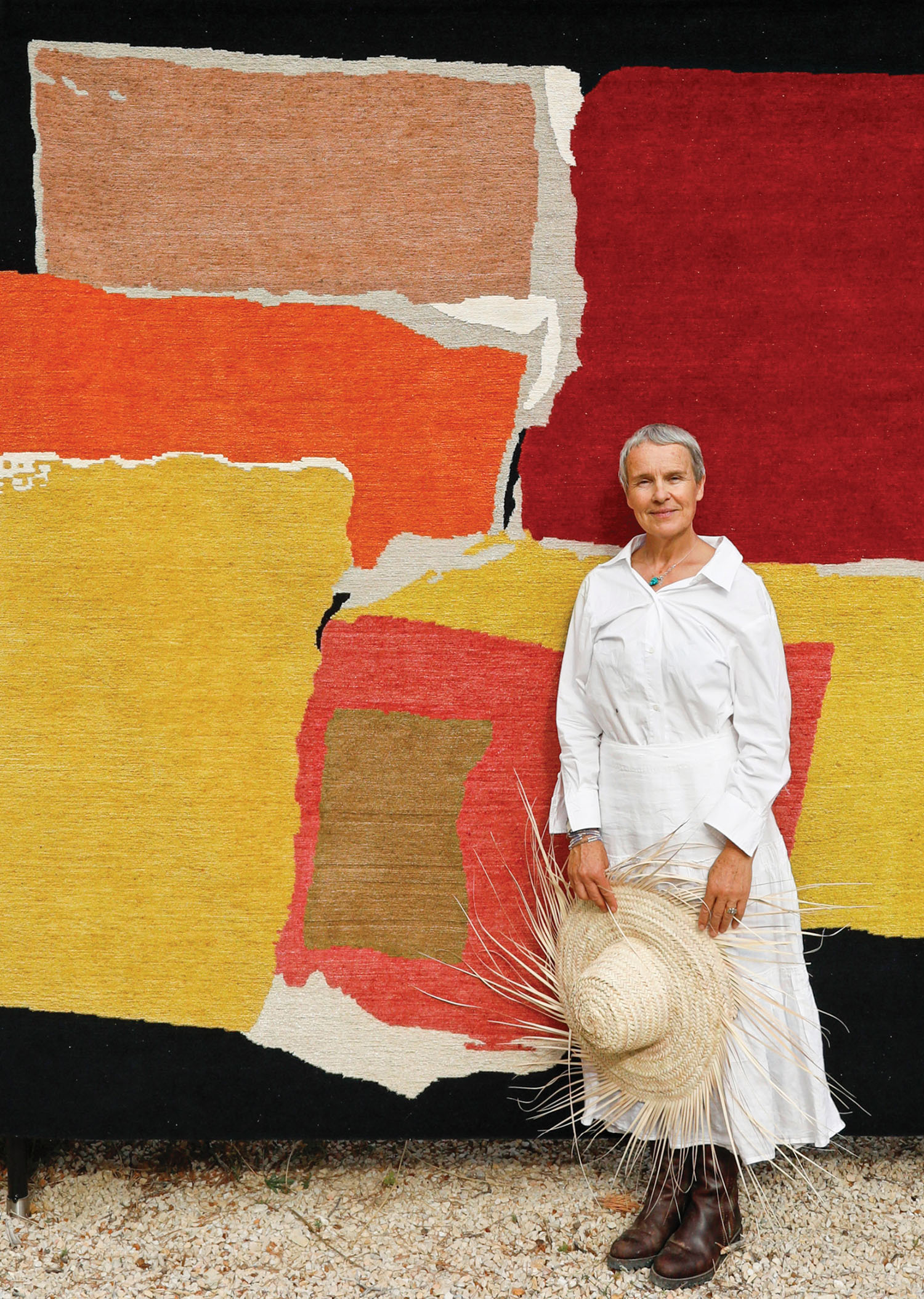 A woman standing in front of a wall with a basket