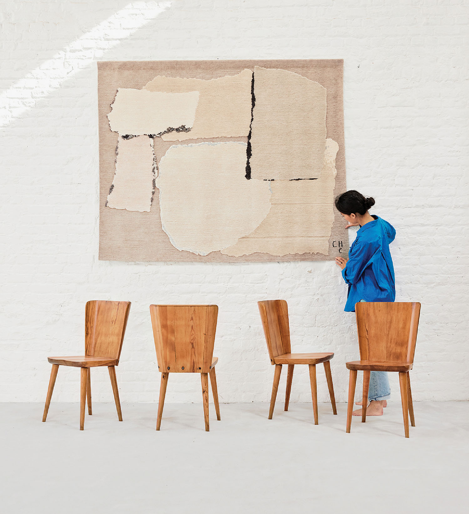 A young woman standing in front of a painting