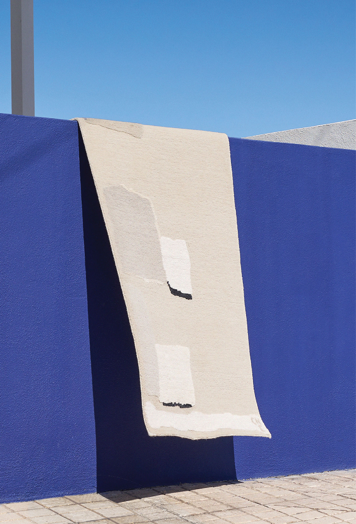 A blue wall with a white piece of paper on it