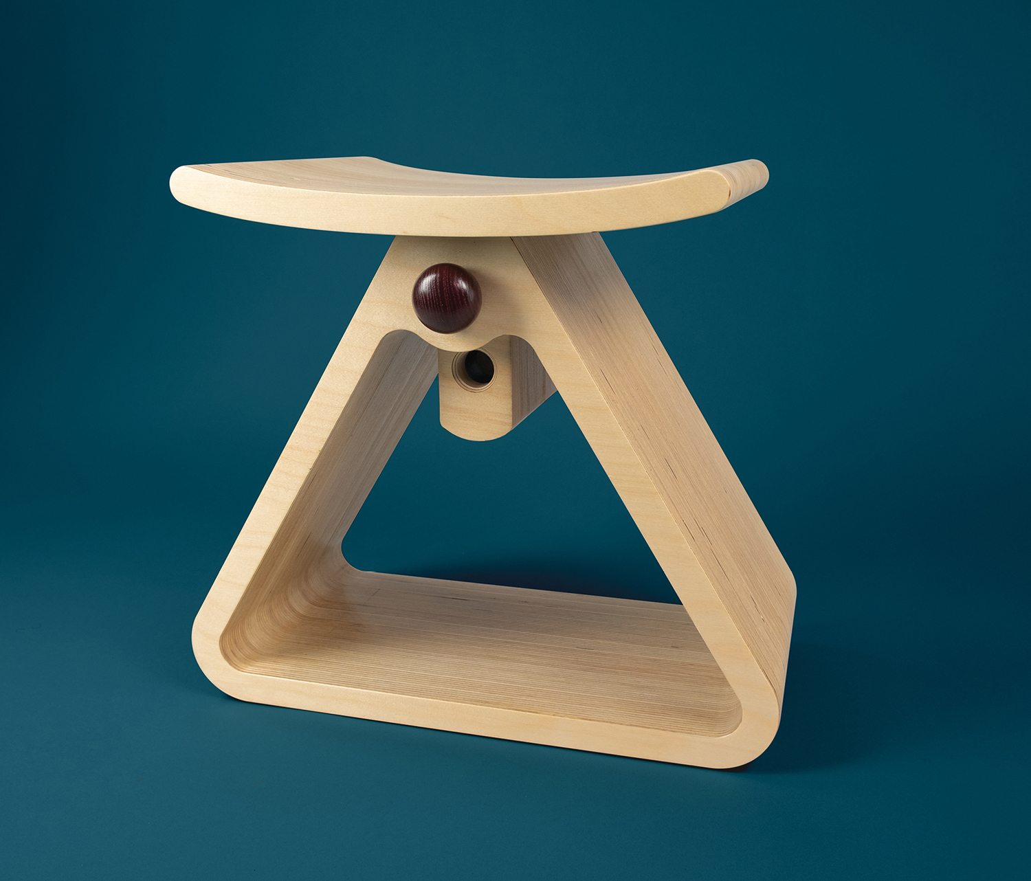 A wooden stool with a ball on top