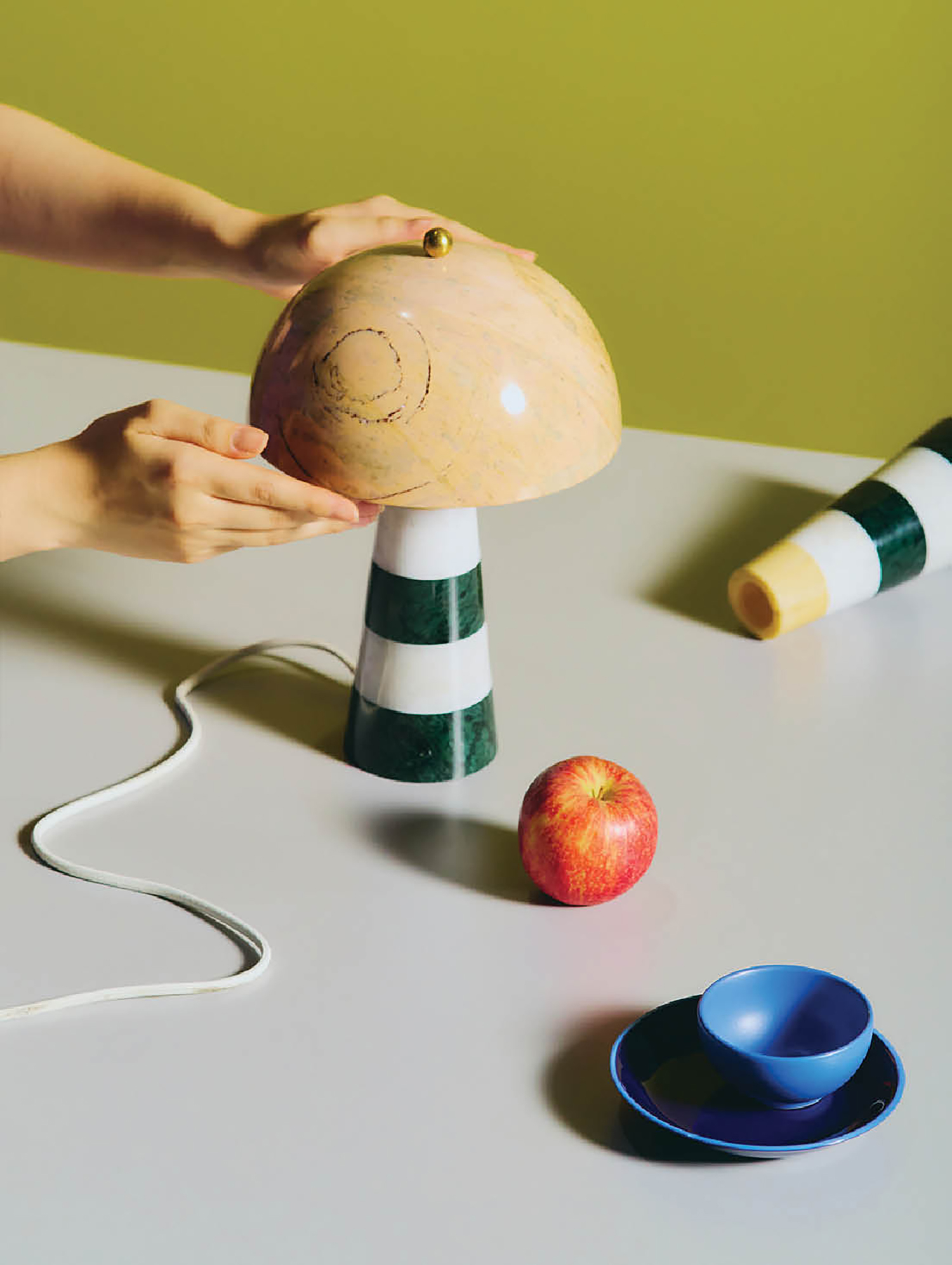 A person is holding a wooden toy