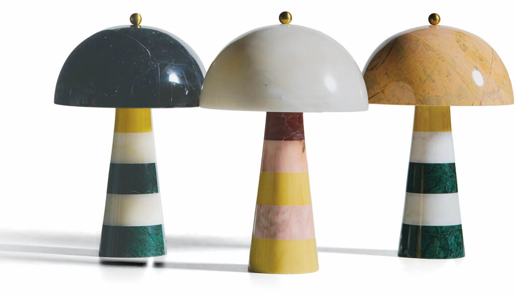 Three different colored lamps on a white background