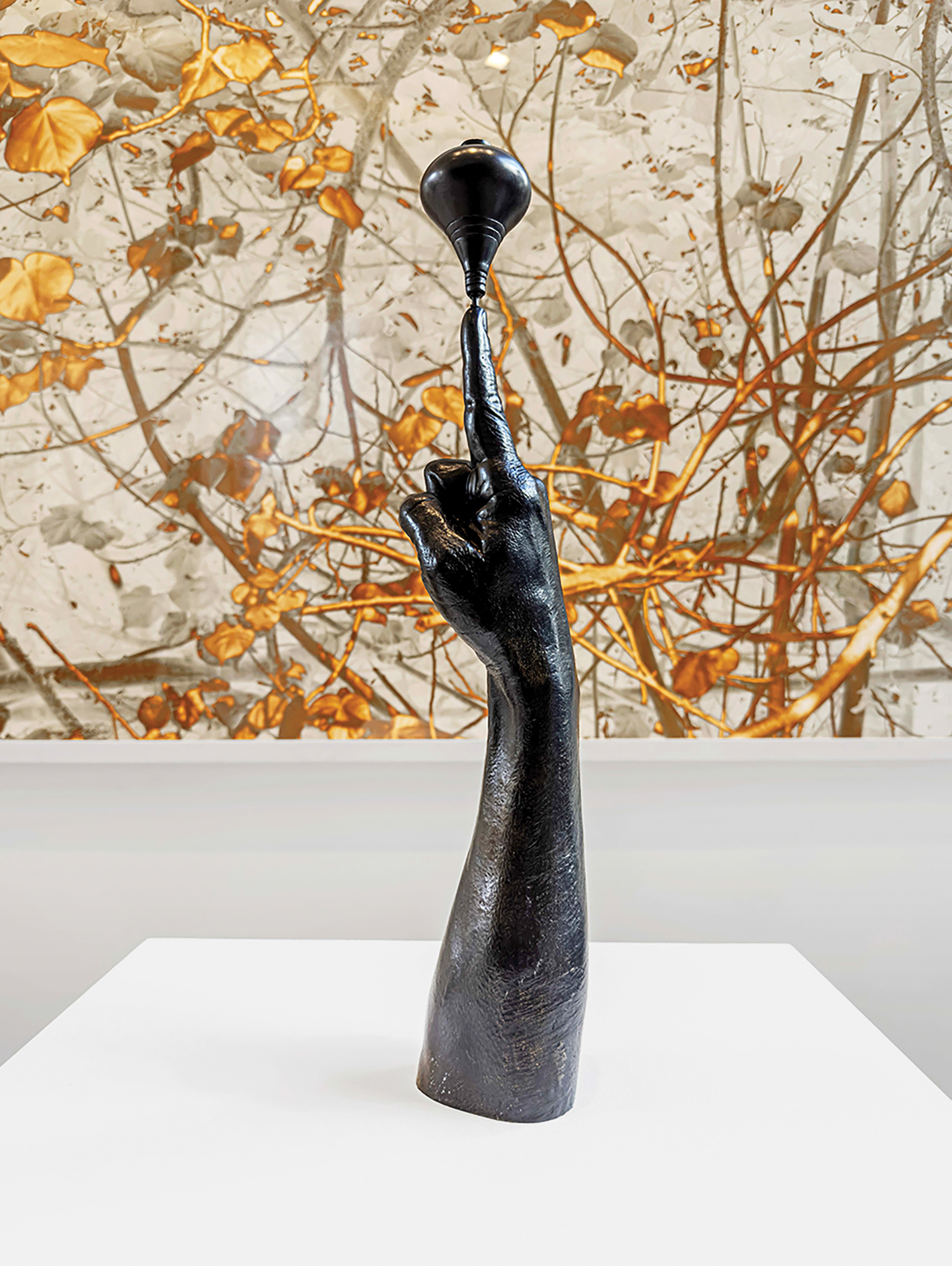 A sculpture of a hand holding a vase