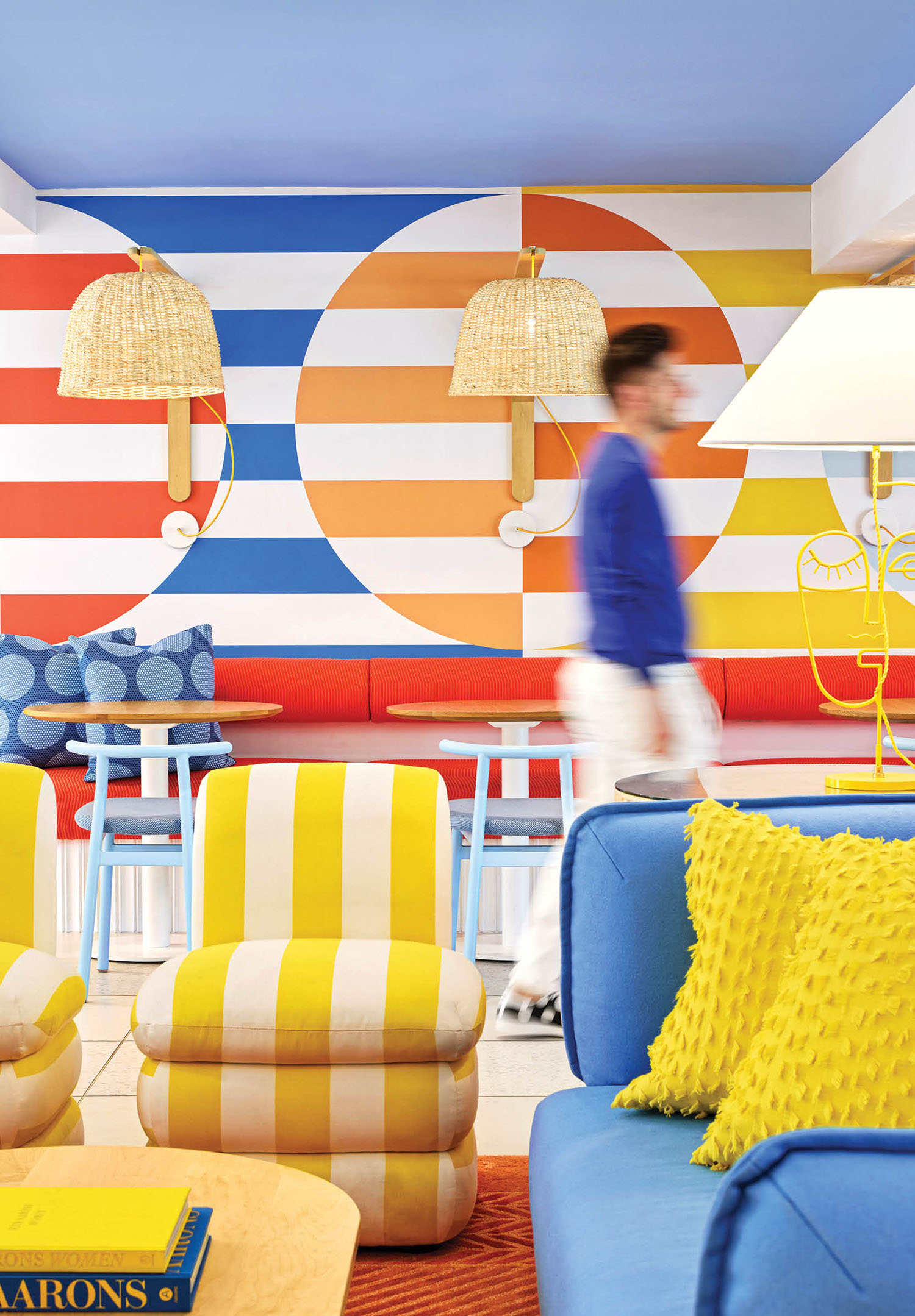 colorful sitting area with yellow cabana stripe chairs and outdoor upholstery