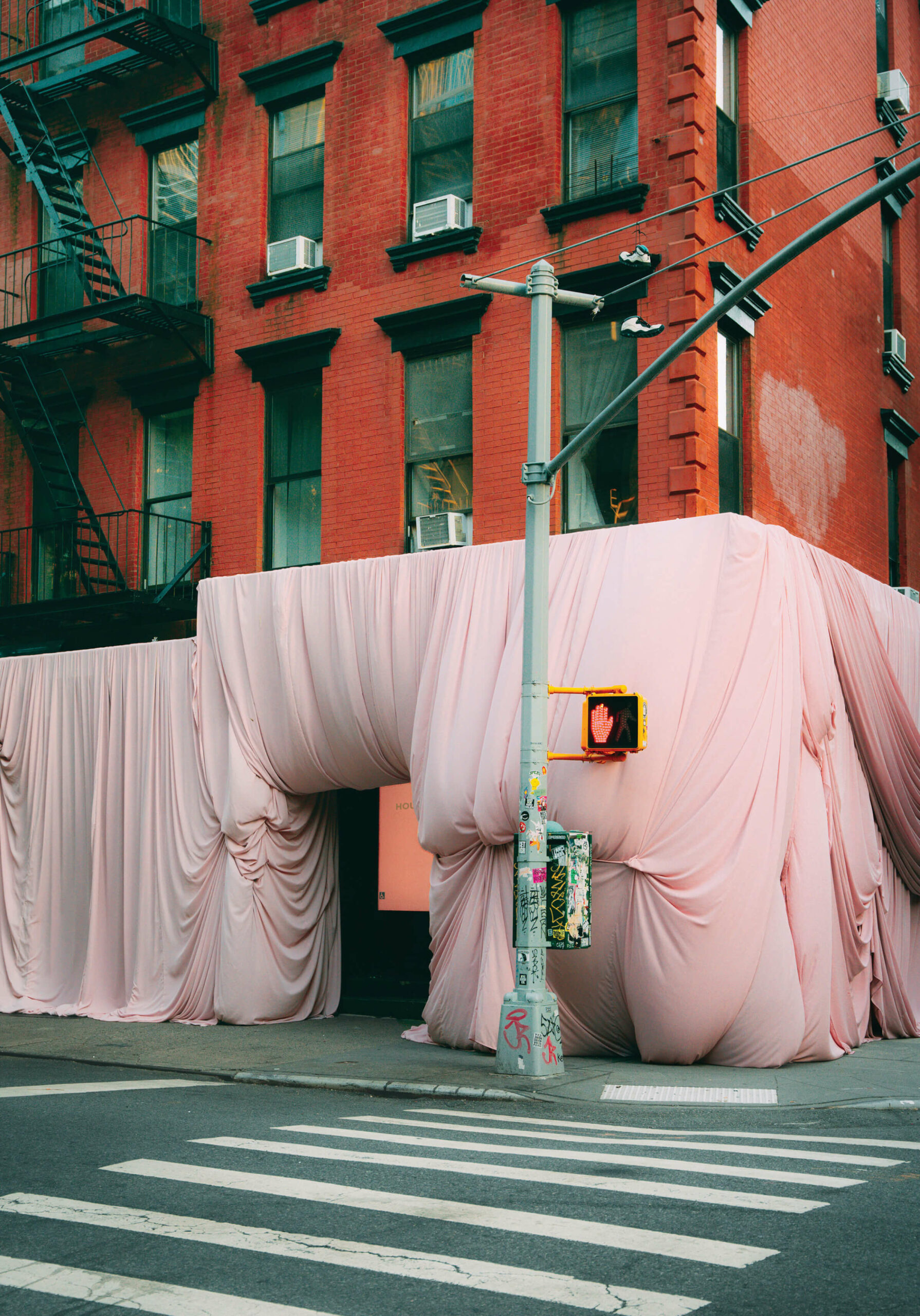 pink drapes cover a New York City building