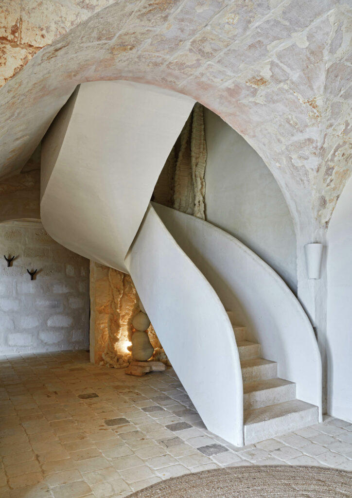 a sculptural staircase in cream hues