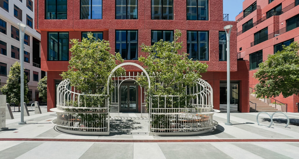 installation outside a brick building with greenery within the structure