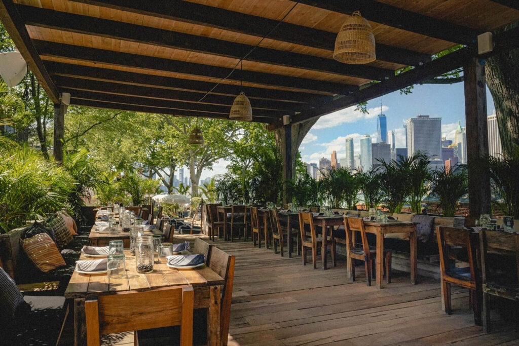 outdoor dining area with wood tables and tropical plants