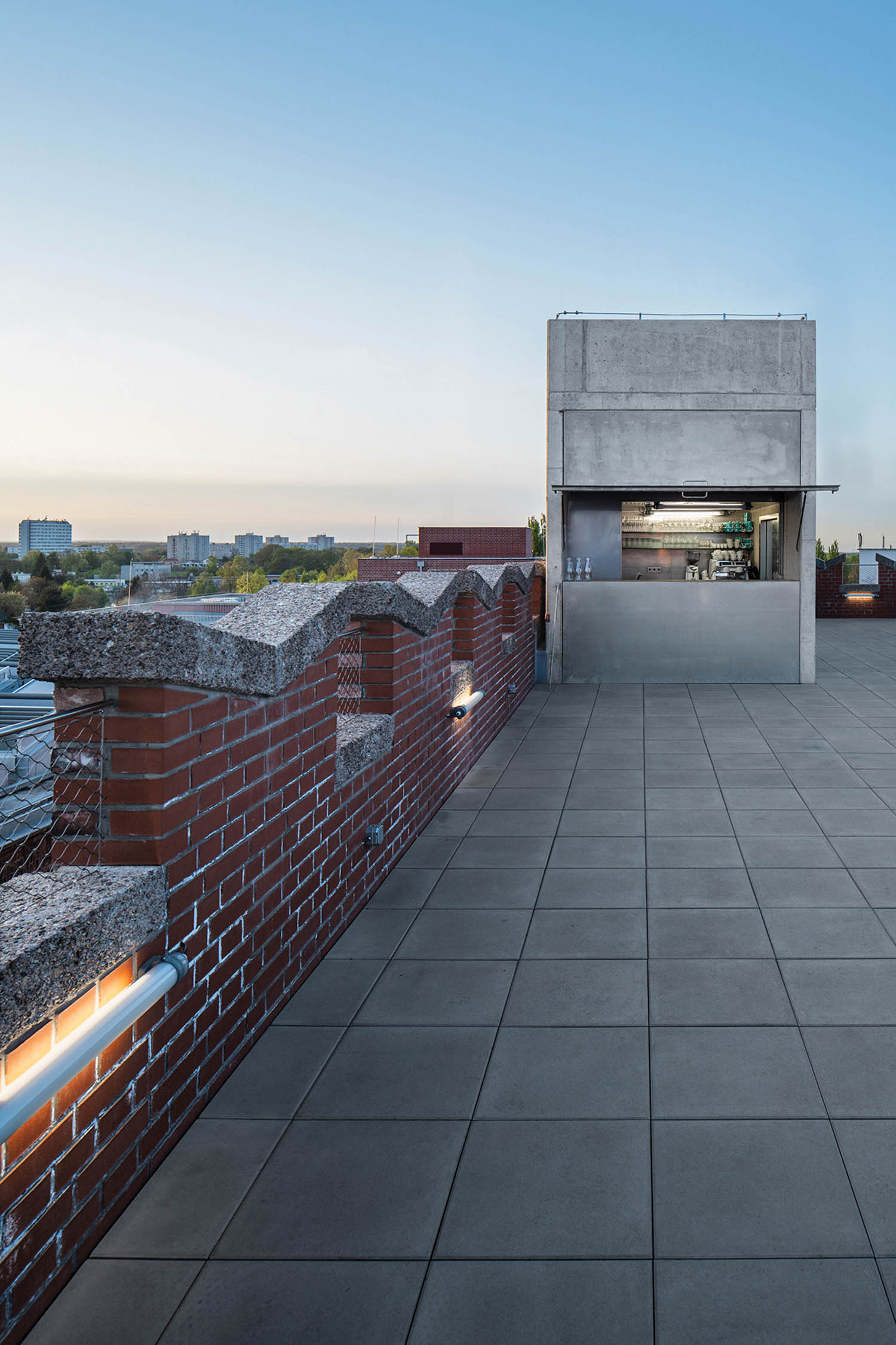 a gray rooftop with brick wall