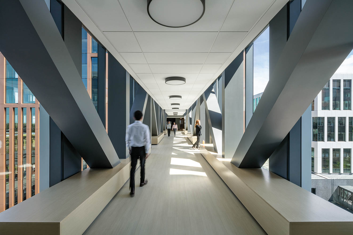 a person walking in a hallway filled with light