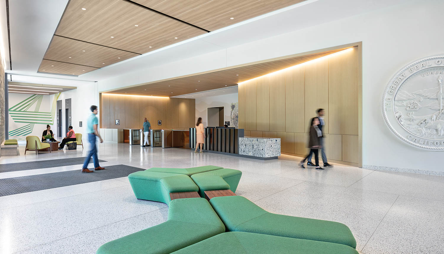 a green bench inside the lobby of Department of General Services, May S. Lee State Office Complex