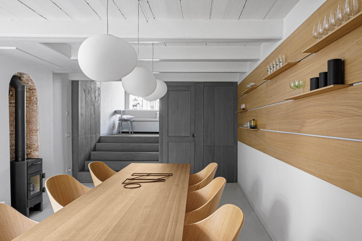 concrete floors in a kitchen with a countertop that extends to create a long dining table