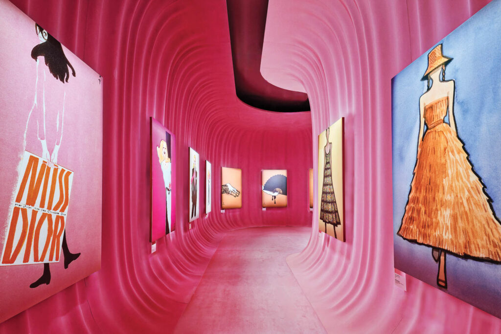 a pink hallway with dior drawings of dresses