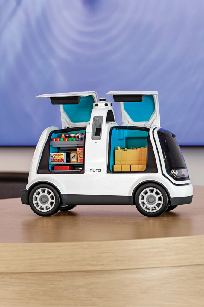 a white mini electric car model with open doors