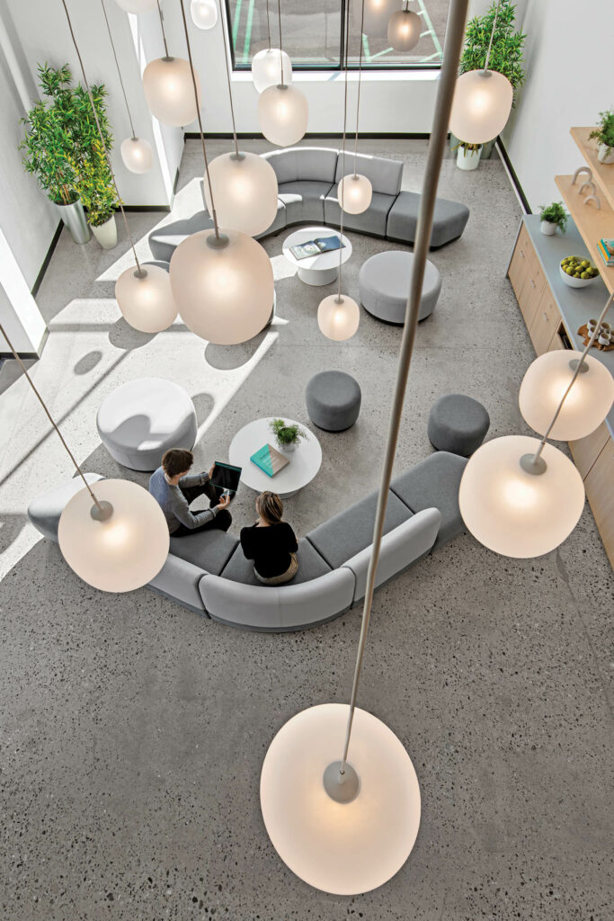 a lounge with gray curves sofa and pendant lights