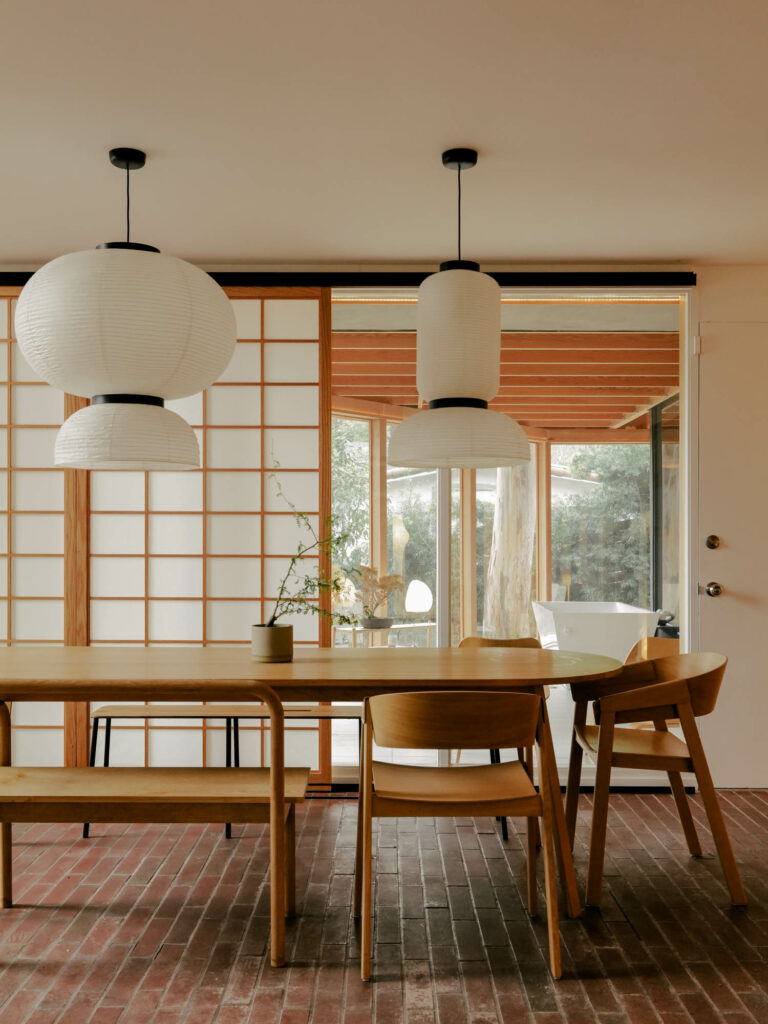 a minimalist dining room with a wood table