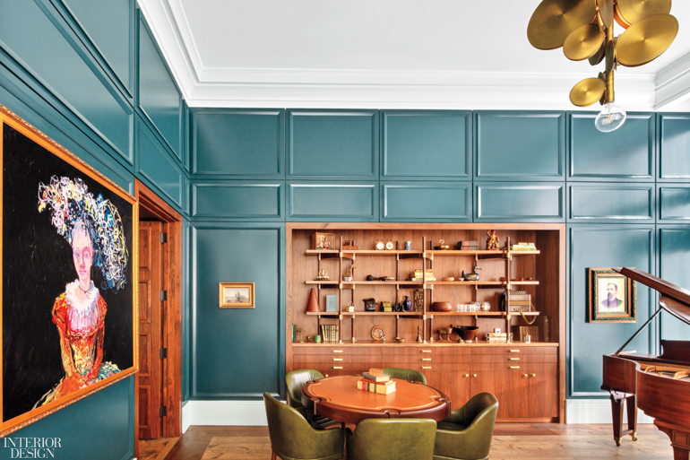 An oil portrait enlivens one wall in this teal room with a wooden bookcase and a grand piano in the Perry Lane Hotel