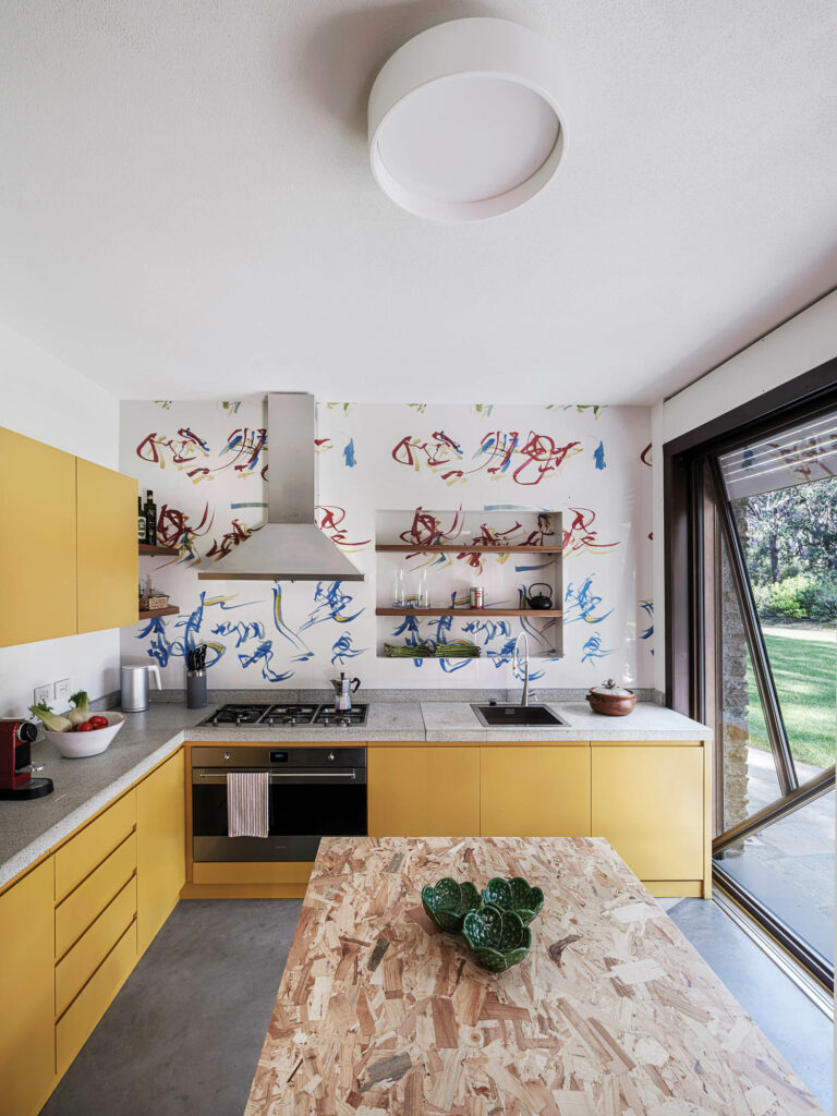 a kitchen with yellow cabinets