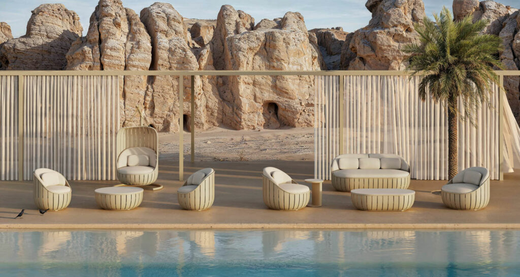 a row of chairs by a pool in front of a mountain scape