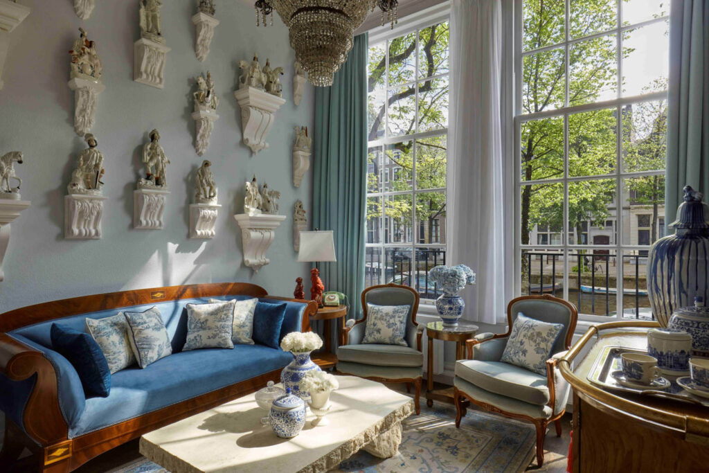 seating area with porcelain plates on the wall, fancy couch and garden views