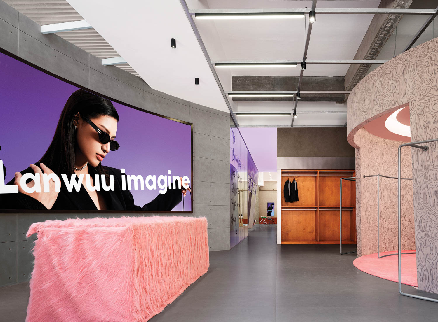 reception area with lots of photography billboards and pink furnishings