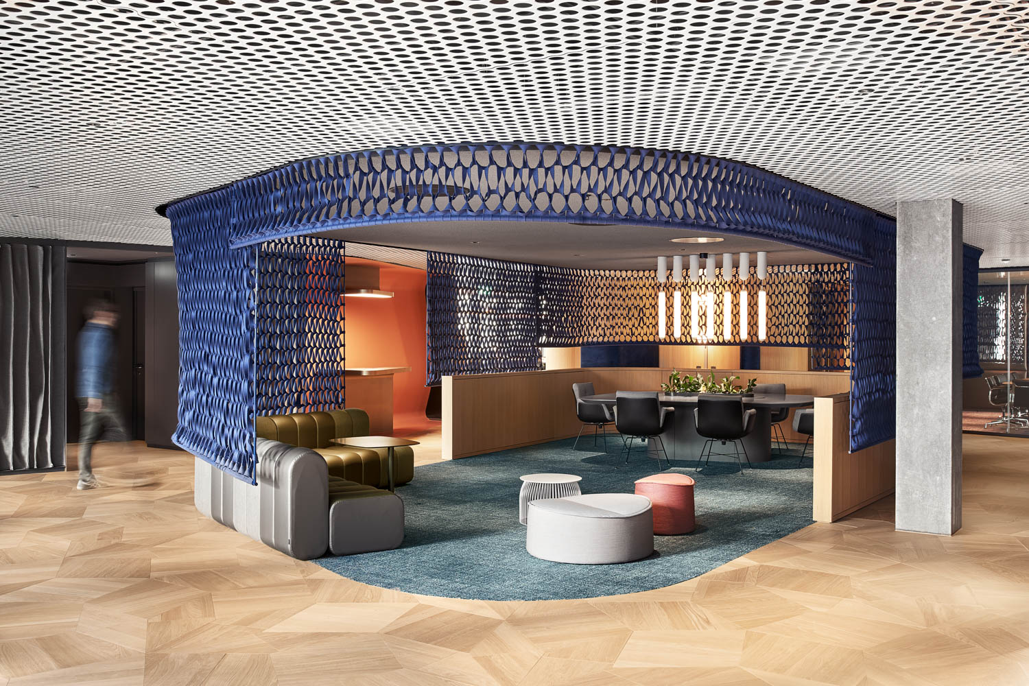 lobby area of the hyatt with blue rug, funky armchairs and blue latticed structure