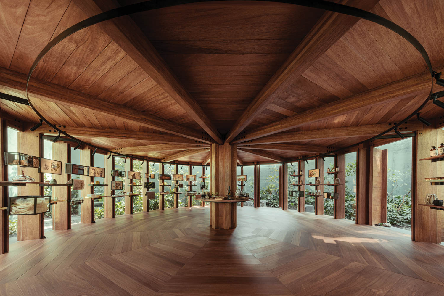 open pavilion with wooden ceilings and floors with screens and shelves all around