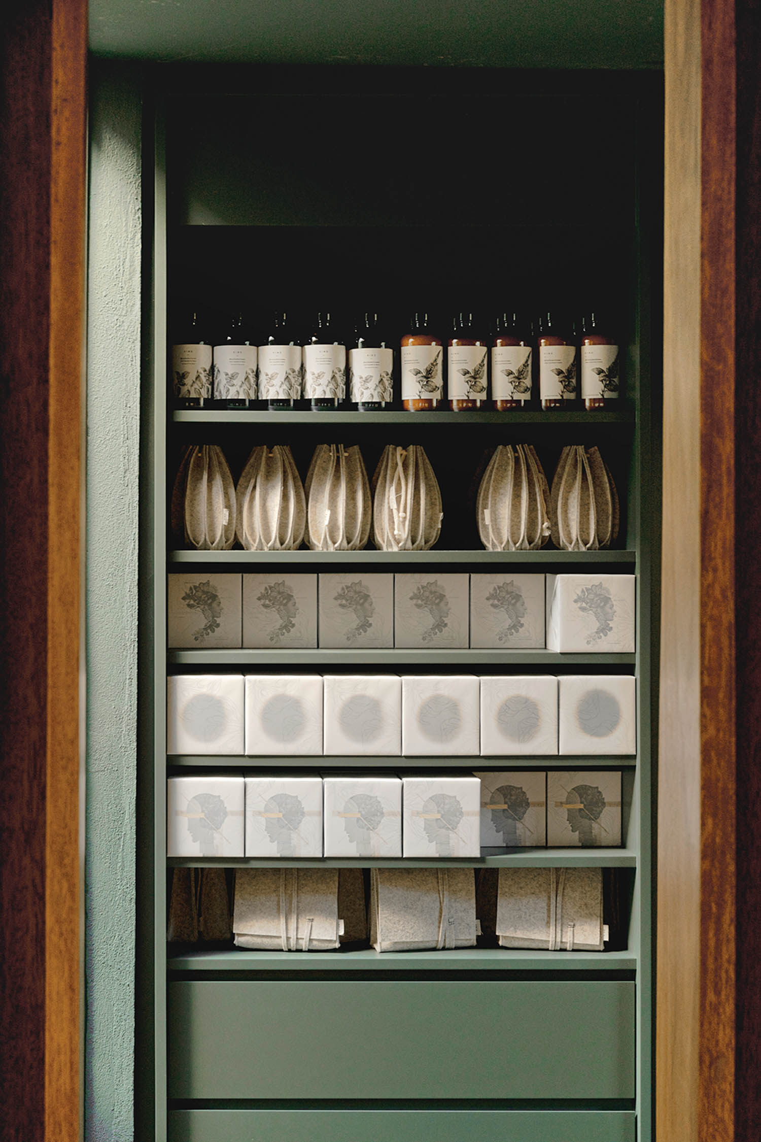 green shelf with multiple different items and packaged goods