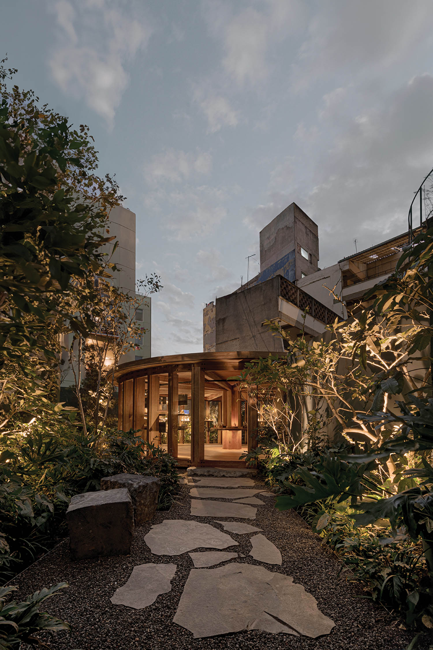 outdoor view of the pavilion amidst the trees with a cobblestone pathway