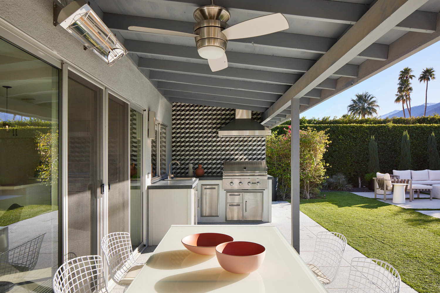 outdoor kitchen and patio with dining area and grill area