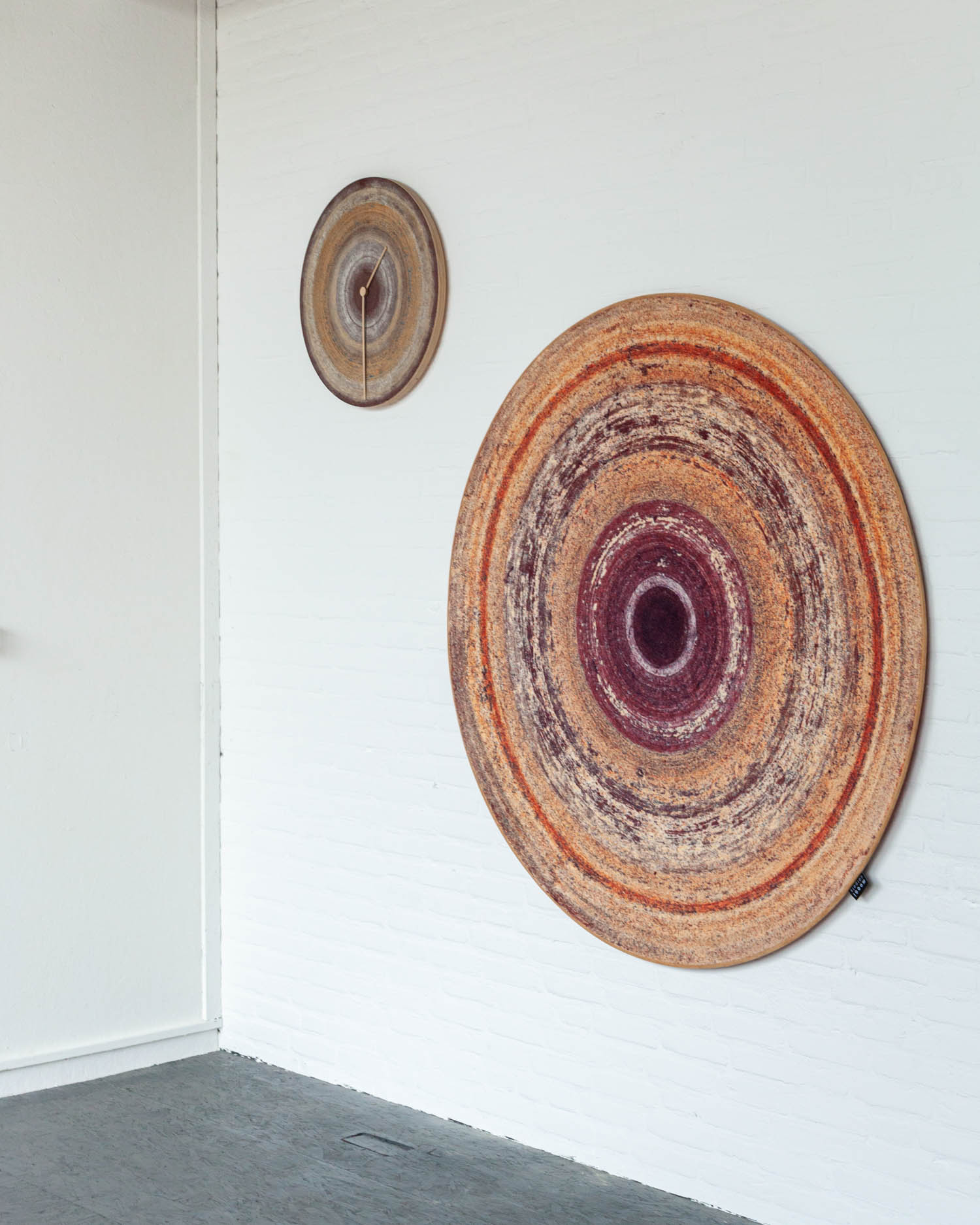 circular brown and red disks hanging on the wall