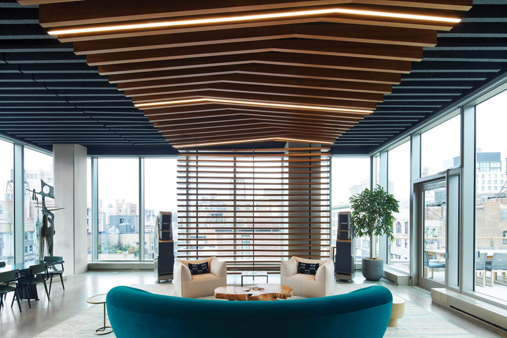 lounge area with teal chair and ceiling lights