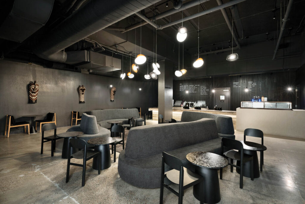 dining room with moody lighting and curved furniture