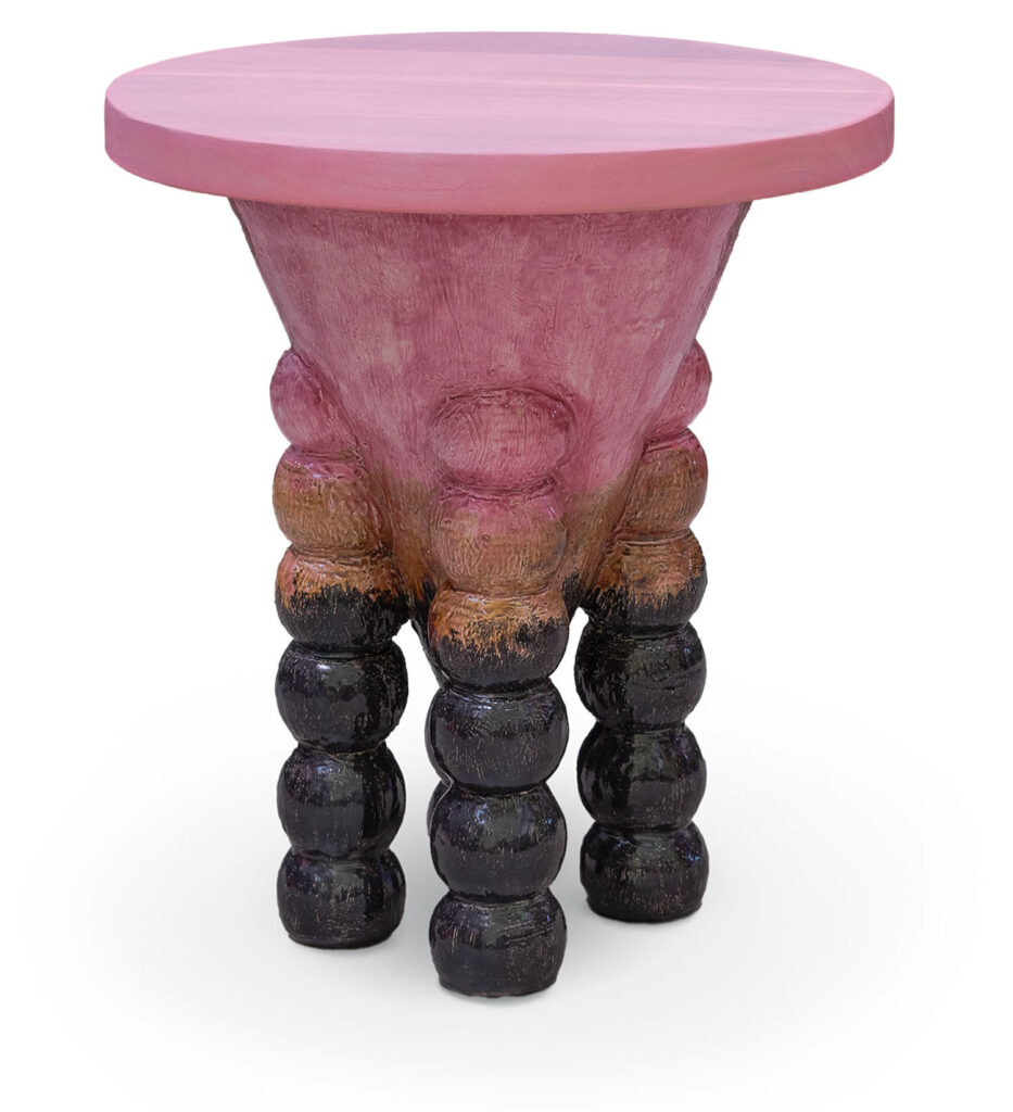 pink end table with stacked round legs