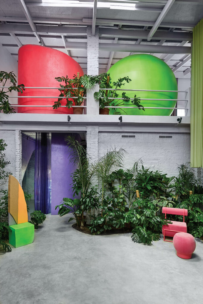 area of home with balcony, shrubbery and brightly colored fixtures