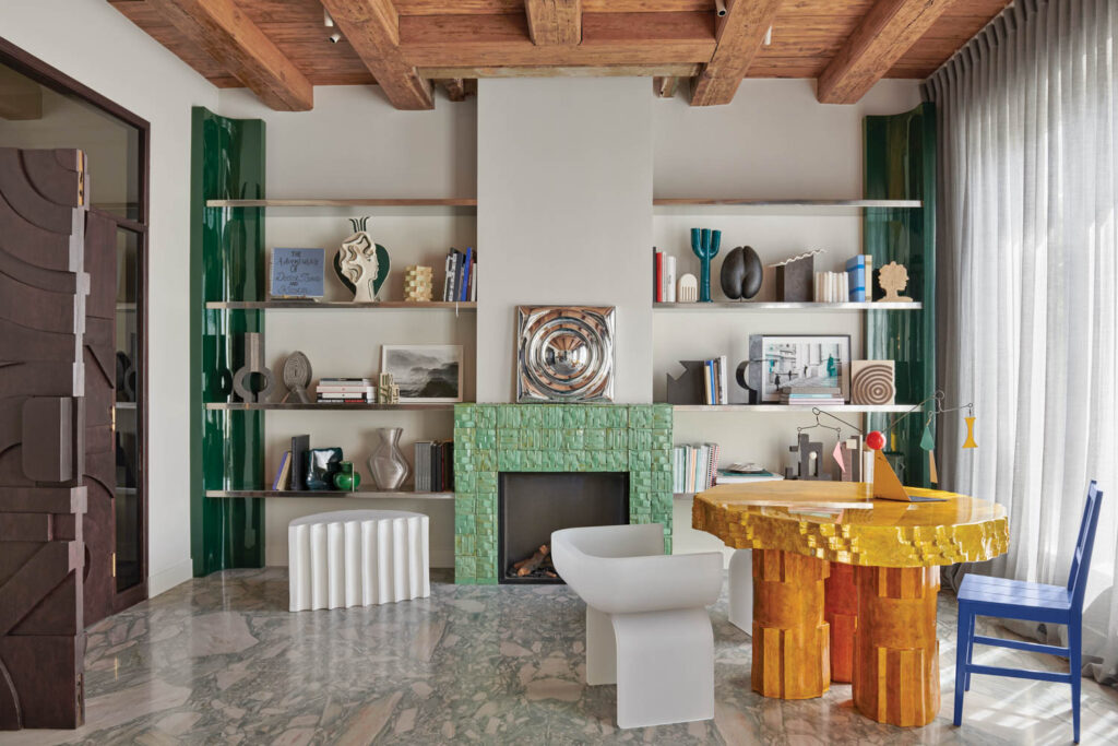 living room with mint green fireplace and yellow table