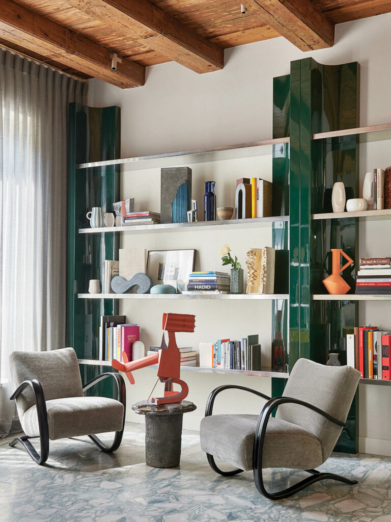 study area with tall shelves, green pillars and chairs