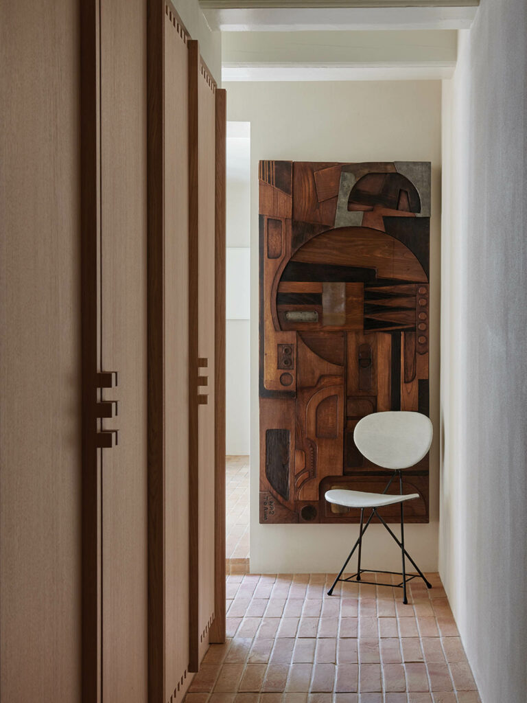 hallway with wooden closet and large artwork