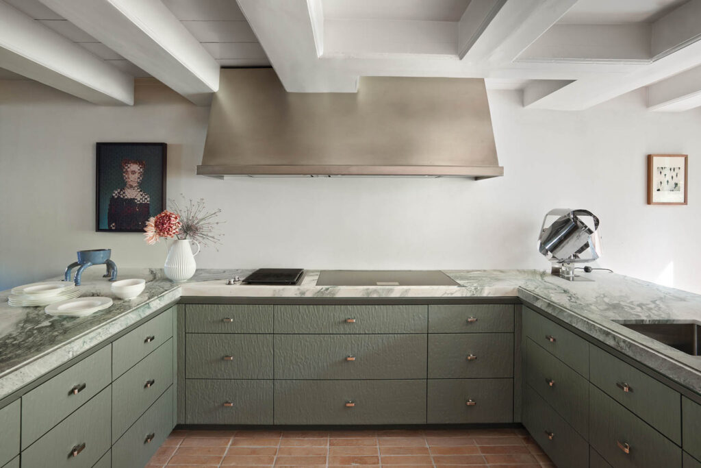 kitchen with pale green drawers and white beam ceilings