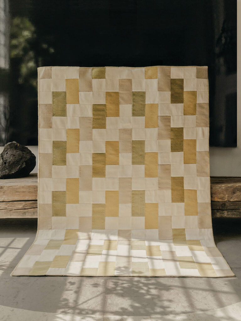 patterned quilt against a wooden platform