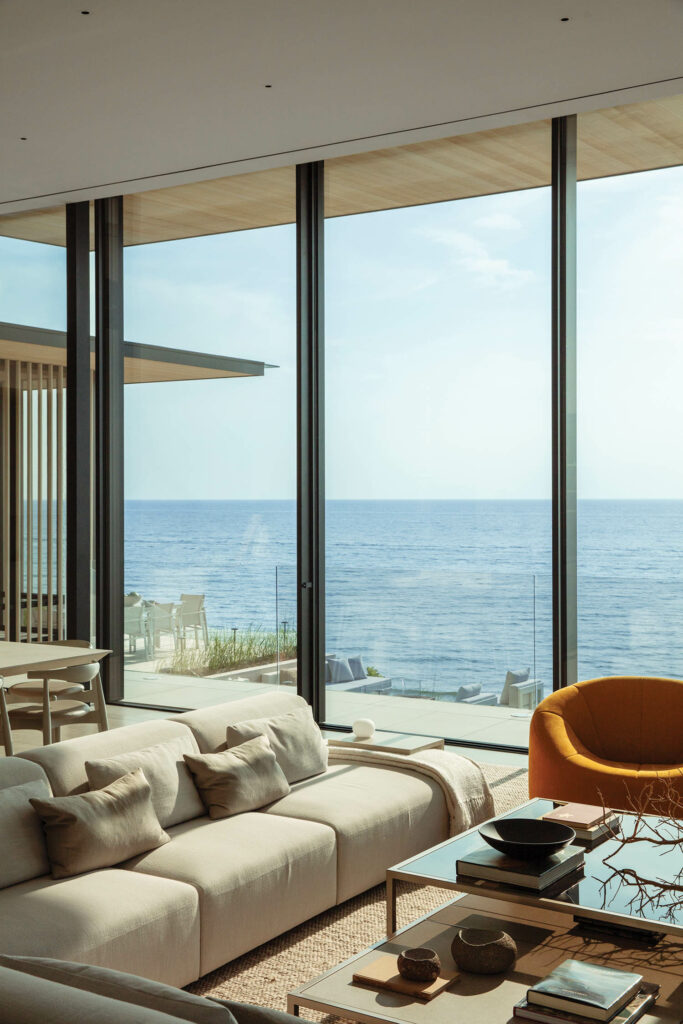 living area with white sectional and orange chair