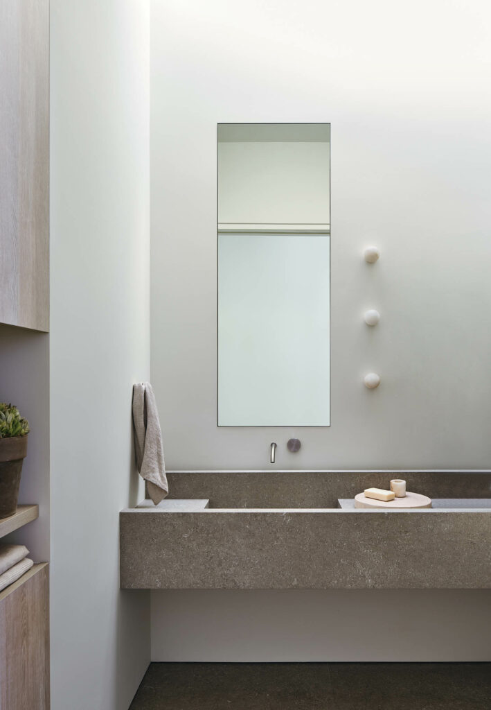 powder room with stone fixtures and mirror