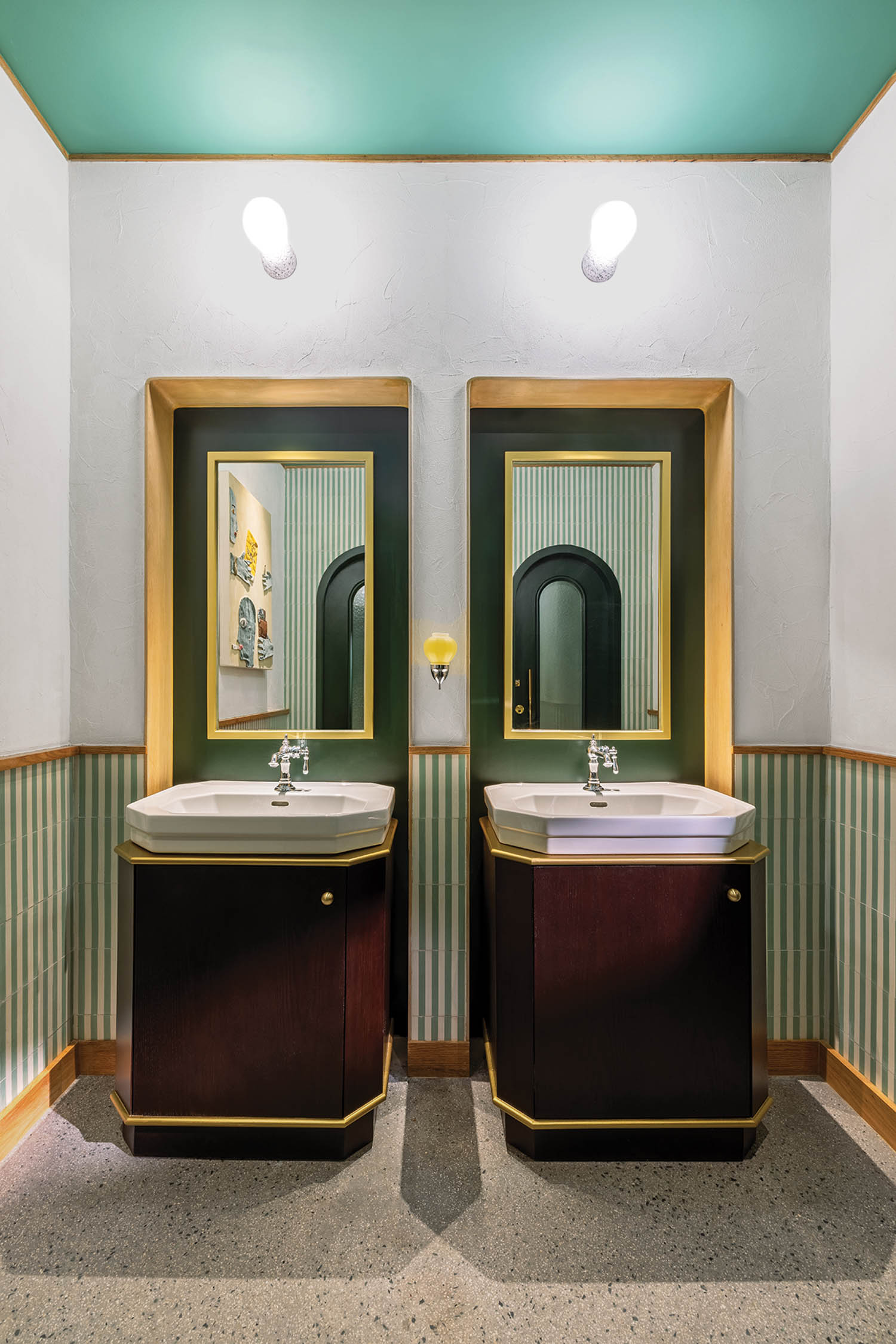 bathroom with green ceiling, green fluted wall and vanities with gold and green mirror