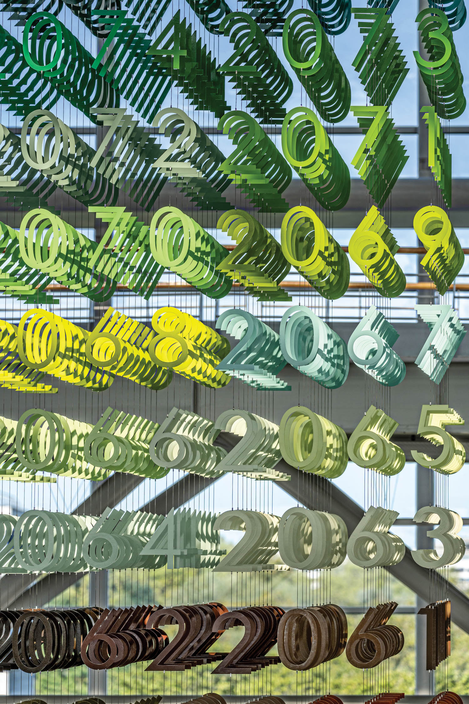 wall of numbers hanging in front of a glass window