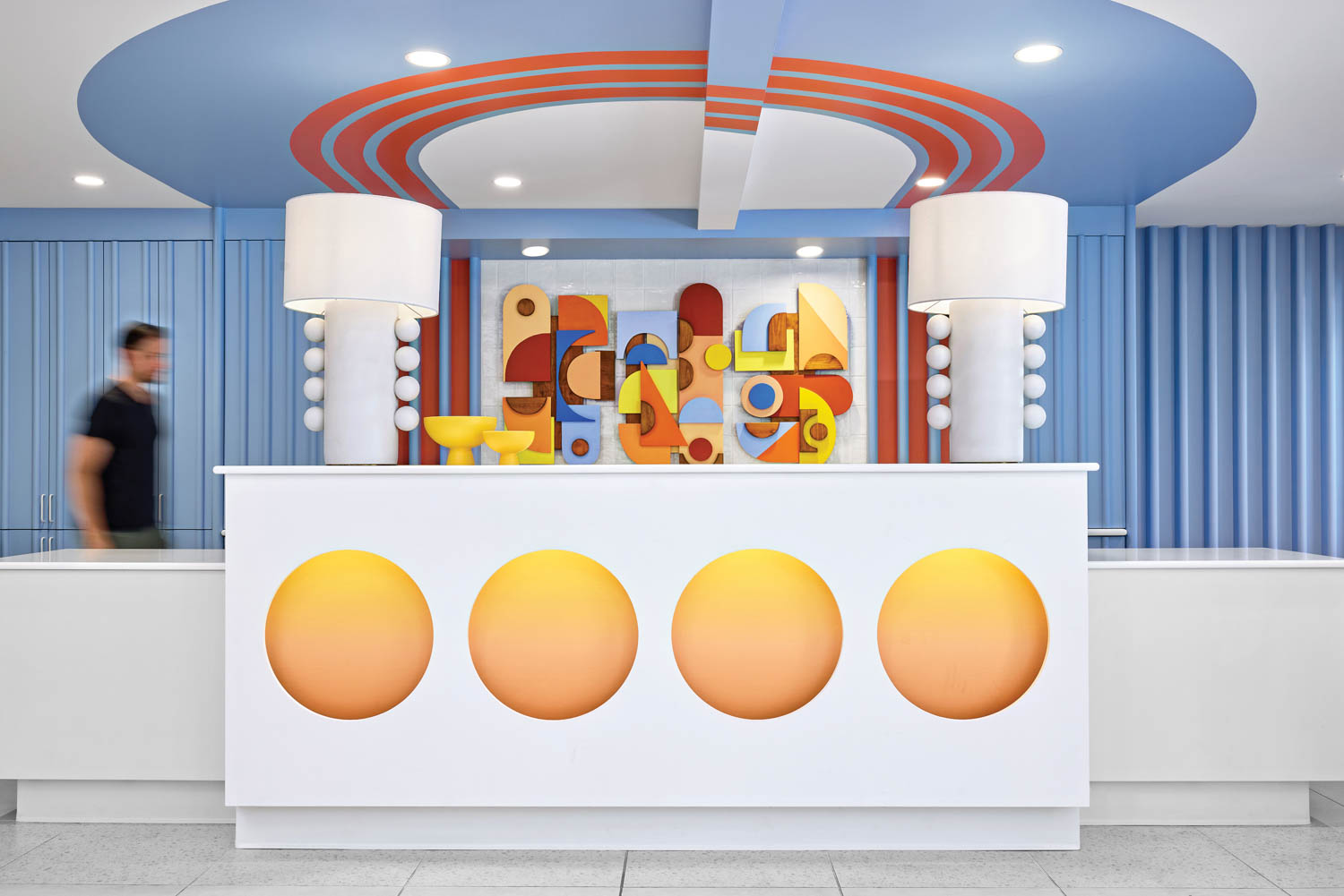 Reception desk with a dimensional painted-wood artwork inset with ombre vinyl circles