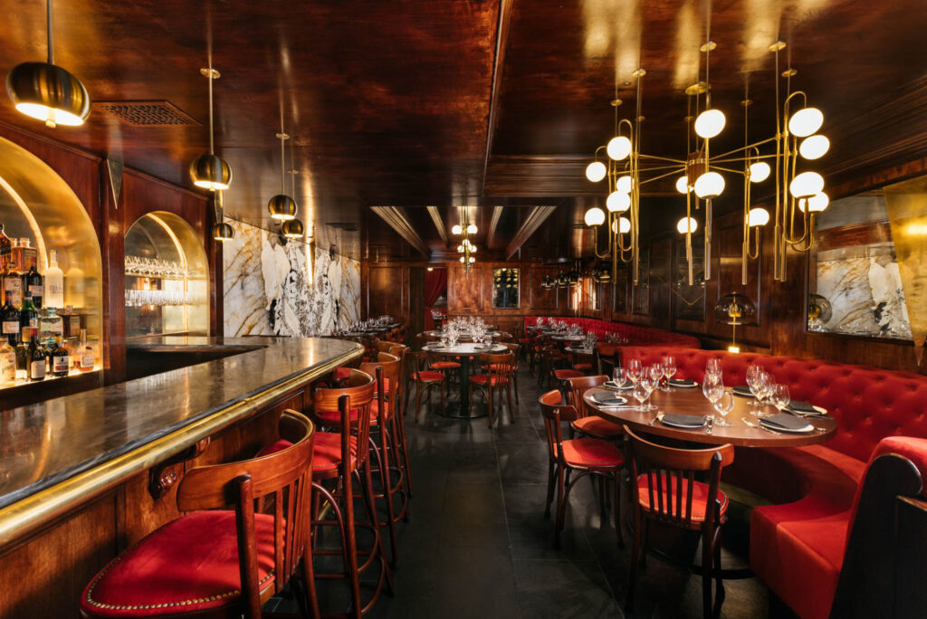 swanky dining area with bright red banquettes and lights