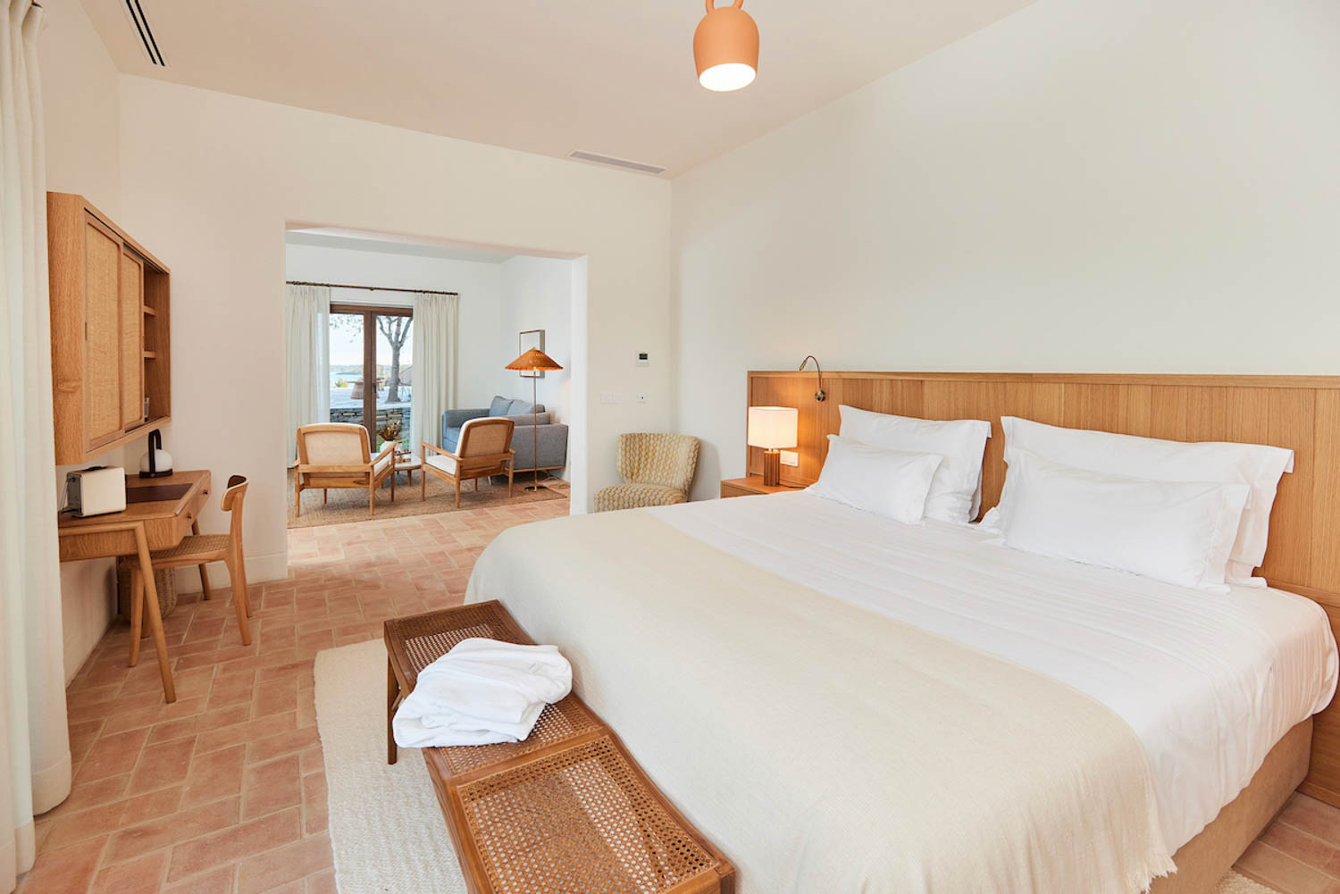 guest bedroom with white sheets and lots of light